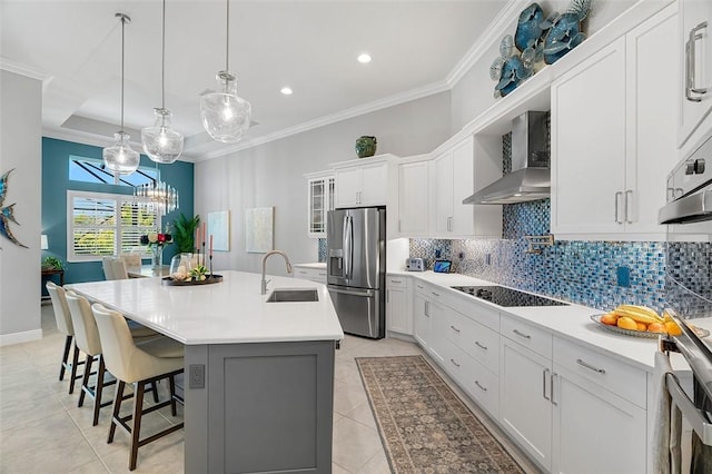 kitchen with stainless steel fridge with ice dispenser, wall chimney range hood, a sink, black electric cooktop, and decorative backsplash