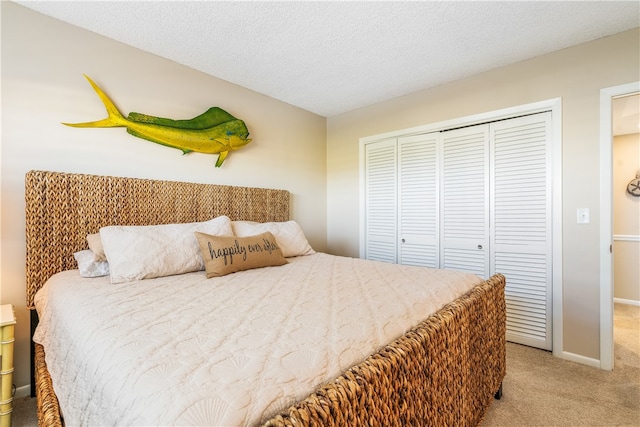 carpeted bedroom with a textured ceiling and a closet