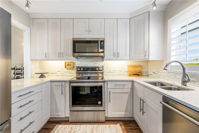 kitchen with white cabinets, dark hardwood / wood-style flooring, sink, and appliances with stainless steel finishes