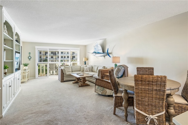 carpeted living room featuring a textured ceiling