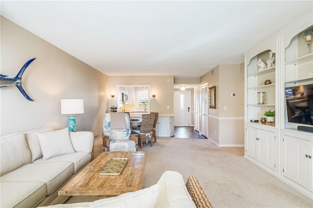 carpeted living room featuring a textured ceiling