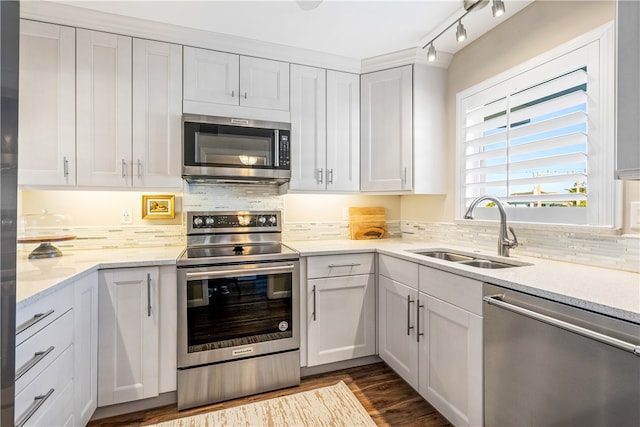 kitchen with white cabinetry, appliances with stainless steel finishes, and sink