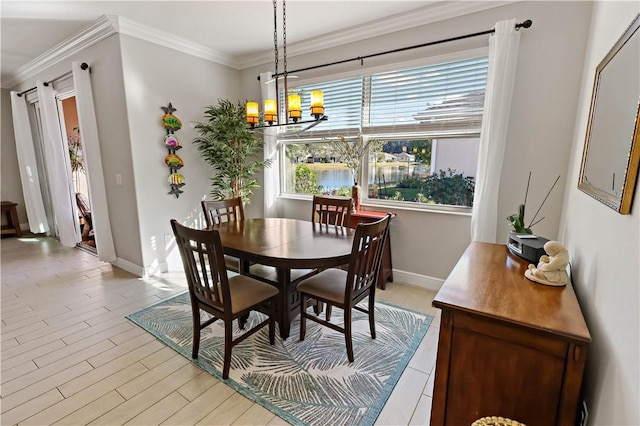 dining room featuring baseboards, an inviting chandelier, crown molding, and light wood finished floors