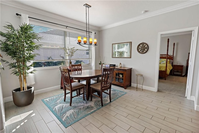 dining area with light wood finished floors, a chandelier, crown molding, and baseboards