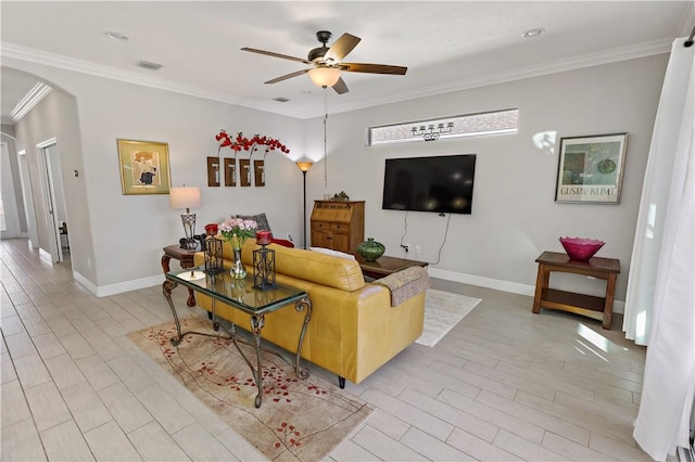 living area featuring arched walkways, visible vents, a ceiling fan, and ornamental molding