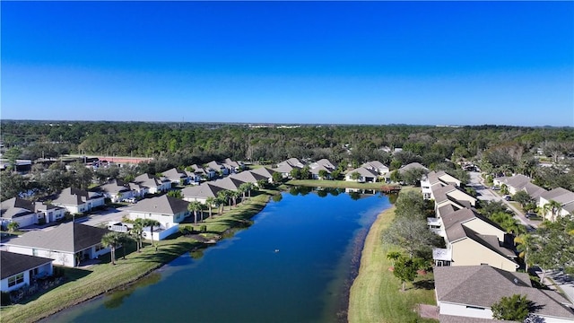 aerial view with a forest view, a residential view, and a water view