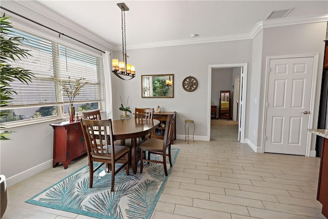 dining room with baseboards, visible vents, a chandelier, and ornamental molding