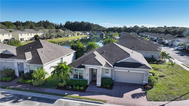 birds eye view of property with a residential view and a water view