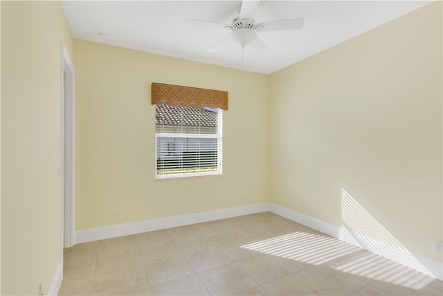 tiled spare room with ceiling fan