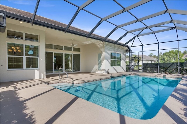 view of swimming pool with ceiling fan, a lanai, and a patio area