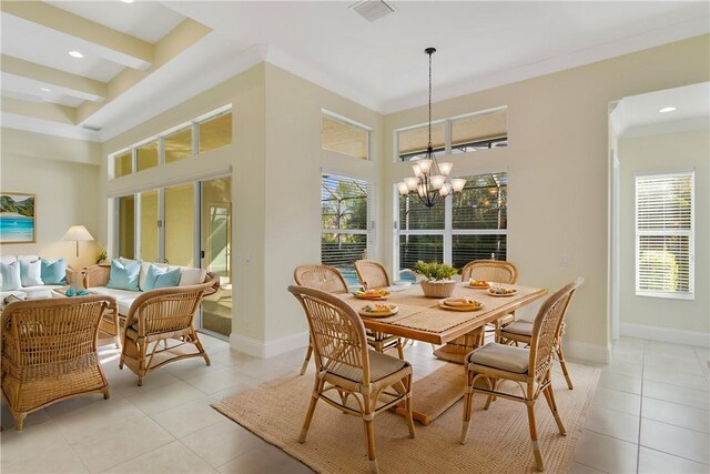 tiled dining area featuring a high ceiling, ornamental molding, and an inviting chandelier