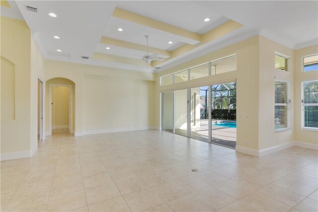 spare room featuring a wealth of natural light, ceiling fan, and a high ceiling