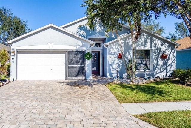 view of front of house with a garage and a front lawn