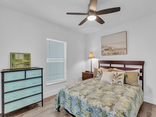 bedroom with ceiling fan and light hardwood / wood-style flooring