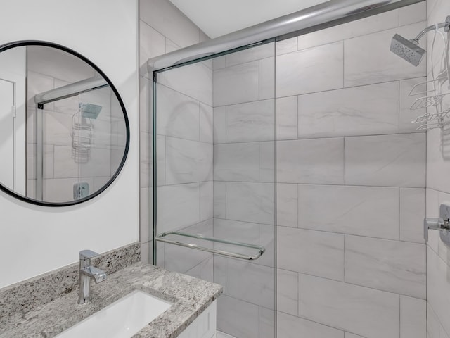 bathroom featuring vanity and an enclosed shower