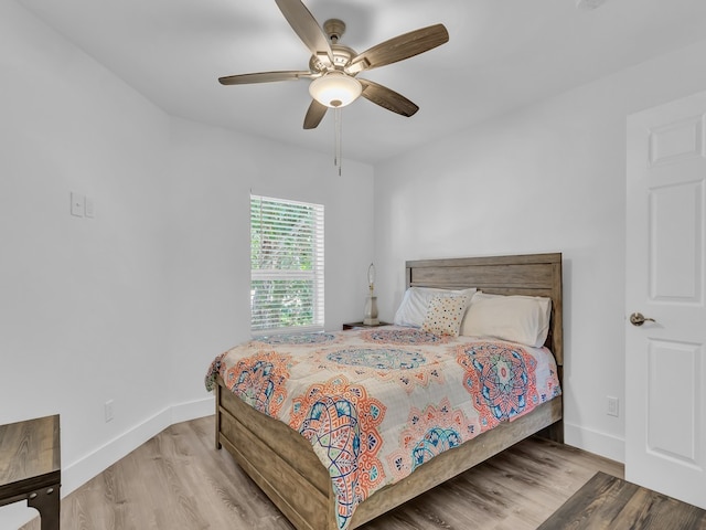 bedroom with light hardwood / wood-style flooring and ceiling fan