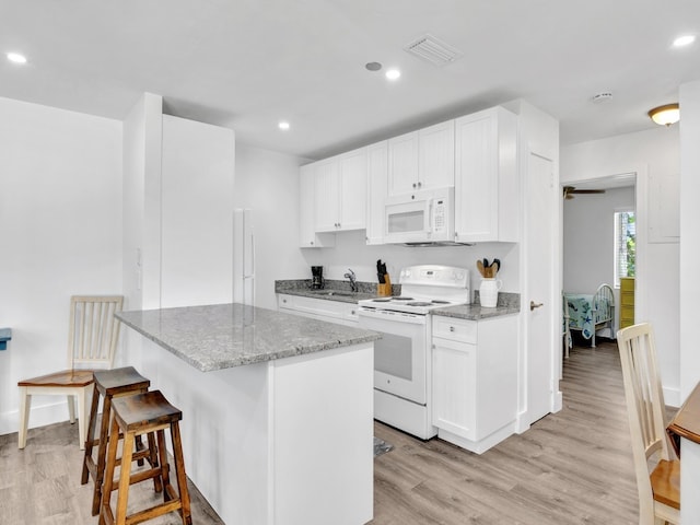 kitchen with white cabinetry, light hardwood / wood-style flooring, sink, and white appliances