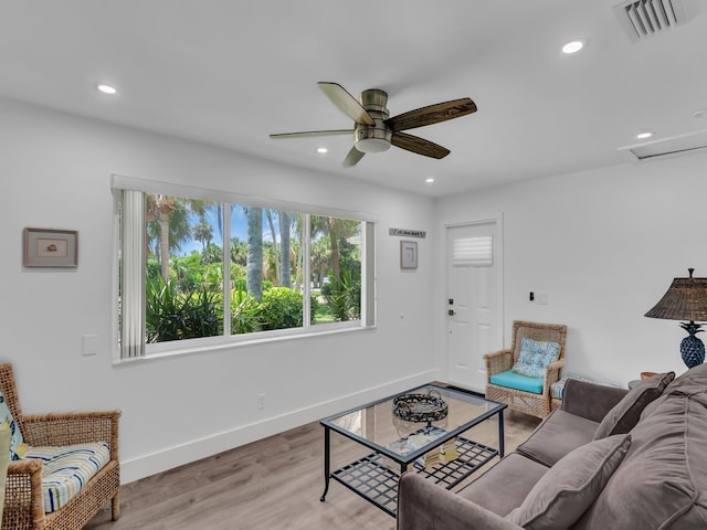 living room featuring light hardwood / wood-style floors and ceiling fan