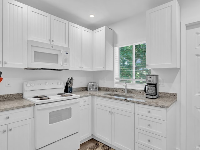 kitchen with white cabinetry, sink, and white appliances