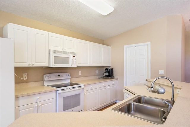 kitchen with white cabinets, white appliances, and a sink