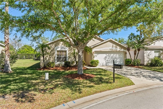 ranch-style home with concrete driveway, a garage, a front yard, and stucco siding