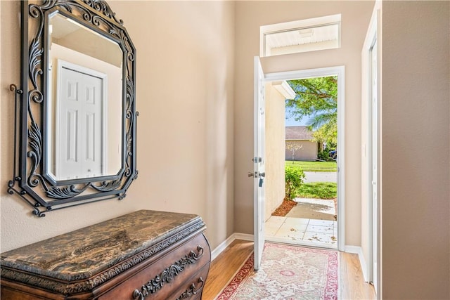 entrance foyer with light wood-style floors and baseboards