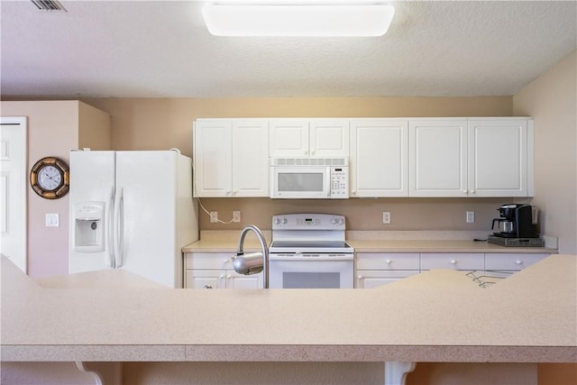 kitchen featuring white cabinetry, white appliances, and light countertops