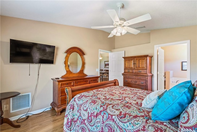 bedroom with wood finished floors, baseboards, visible vents, ceiling fan, and vaulted ceiling