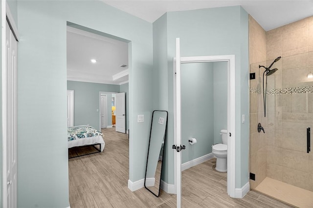 8645 95th Ave, Vero Beach, FL 32967 - ensuite bathroom featuring a shower stall, wood finished floors, toilet, and baseboards