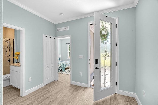 8645 95th Ave, Vero Beach, FL 32967 - entryway with light wood-style flooring, ornamental molding, and baseboards