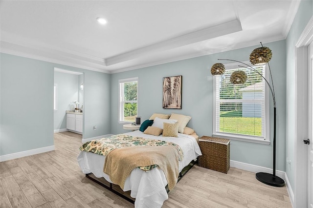 8645 95th Ave, Vero Beach, FL 32967 - bedroom featuring a tray ceiling, crown molding, light wood-type flooring, baseboards, and ensuite bath