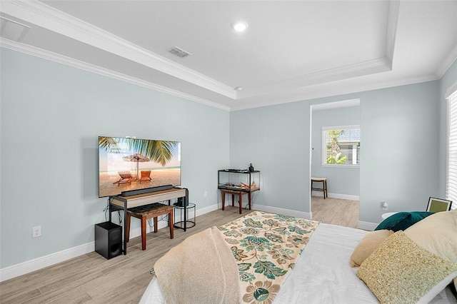 8645 95th Ave, Vero Beach, FL 32967 - bedroom featuring a tray ceiling, light wood-style floors, crown molding, baseboards, and recessed lighting
