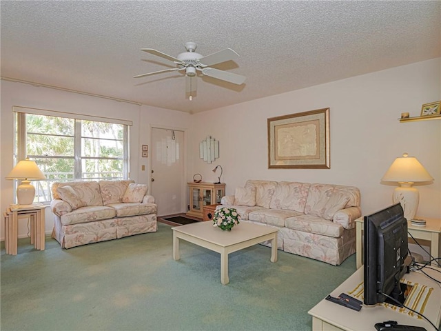 living room featuring ceiling fan, carpet, and a textured ceiling