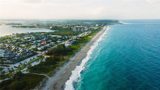 bird's eye view featuring a water view and a beach view