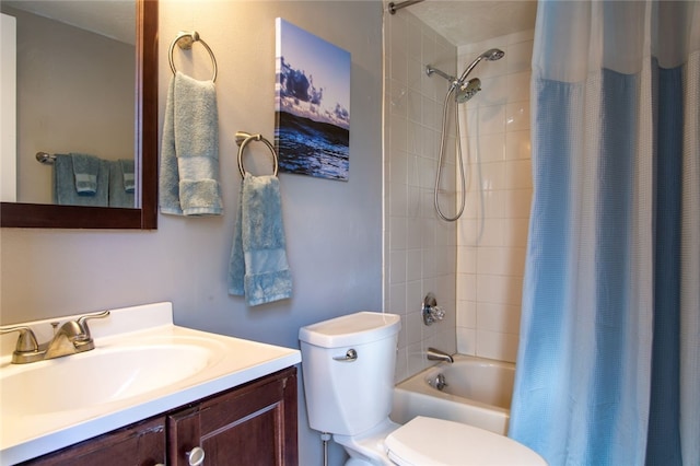 full bathroom with vanity, shower / bath combo, and toilet