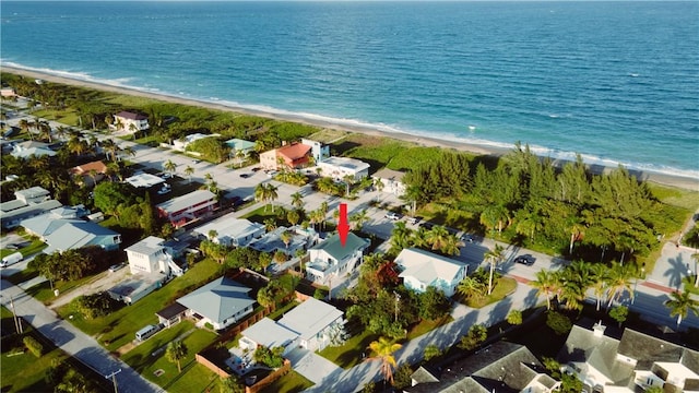 bird's eye view with a water view and a beach view