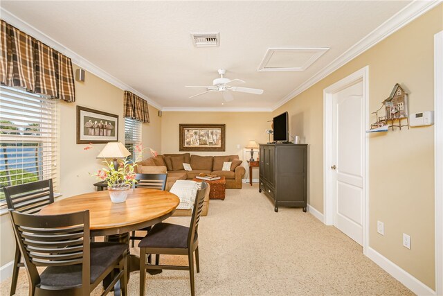 dining space featuring ceiling fan and crown molding