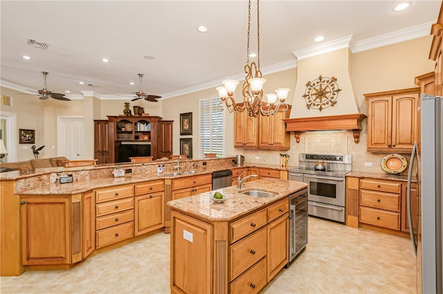 kitchen featuring crown molding, hanging light fixtures, an island with sink, kitchen peninsula, and stainless steel appliances