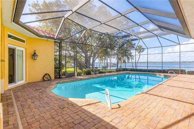 view of swimming pool featuring a patio, a water view, and a lanai