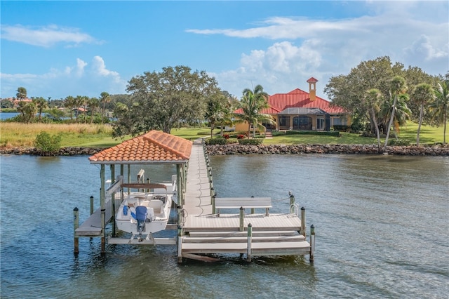 view of dock featuring a water view and a yard