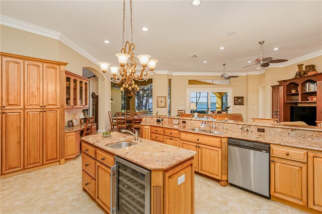 kitchen featuring dishwasher, sink, beverage cooler, pendant lighting, and a kitchen island with sink