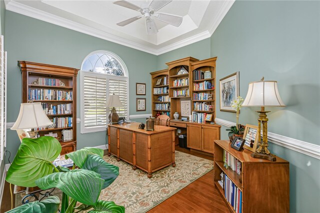 office with dark hardwood / wood-style floors, ceiling fan, a raised ceiling, and ornamental molding