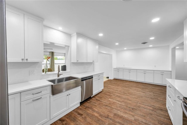 505 19th St, Vero Beach, FL 32960 - kitchen featuring dishwasher, dark wood-style flooring, a sink, and white cabinetry