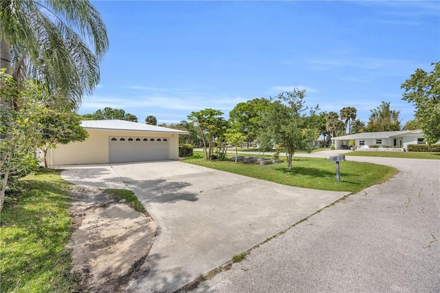 505 19th St, Vero Beach, FL 32960 - single story home featuring driveway, stucco siding, an attached garage, and a front lawn