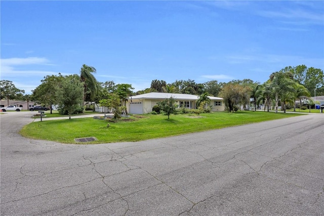 505 19th St, Vero Beach, FL 32960 - view of front of house with driveway, a front yard, and an attached garage