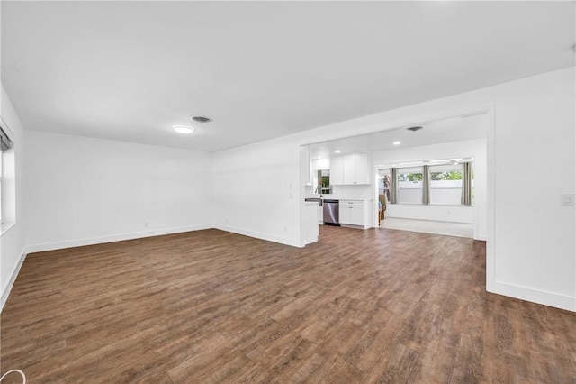 505 19th St, Vero Beach, FL 32960 - unfurnished living room featuring baseboards, visible vents, and dark wood-style flooring