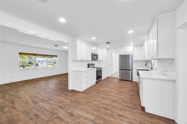 505 19th St, Vero Beach, FL 32960 - kitchen with dark wood-style floors, a sink, stainless steel appliances, and light countertops