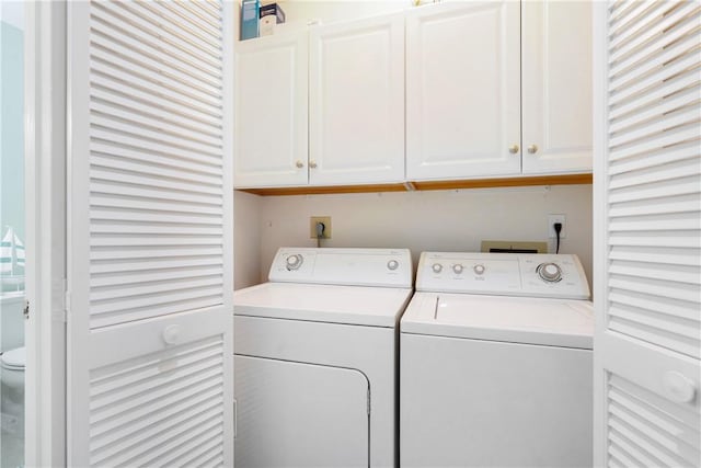 laundry area featuring cabinets and washer and clothes dryer