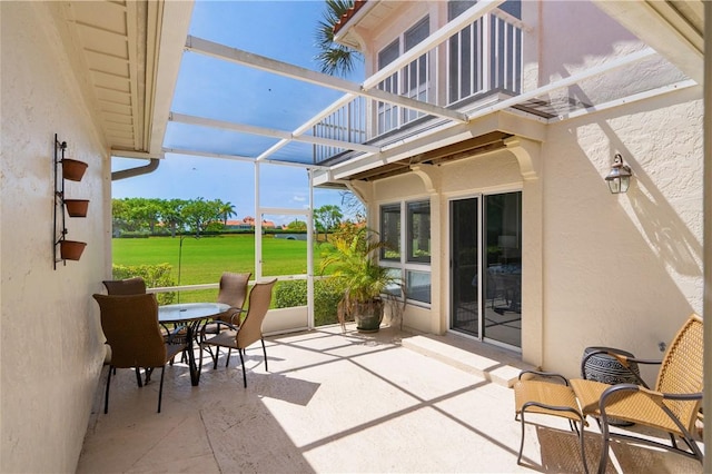 view of patio featuring a lanai and a balcony