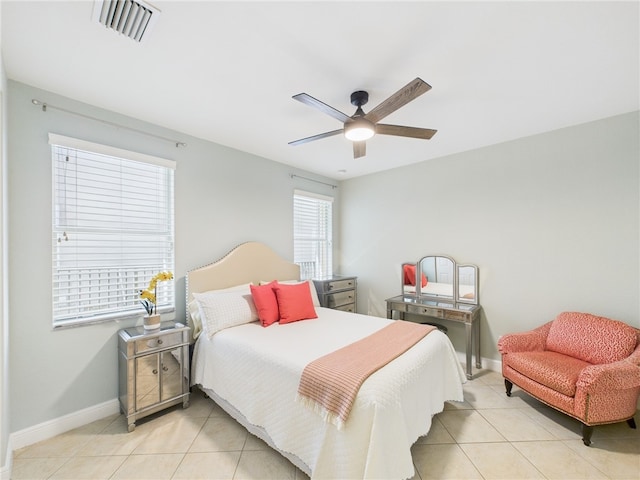 tiled bedroom with a ceiling fan, baseboards, and visible vents